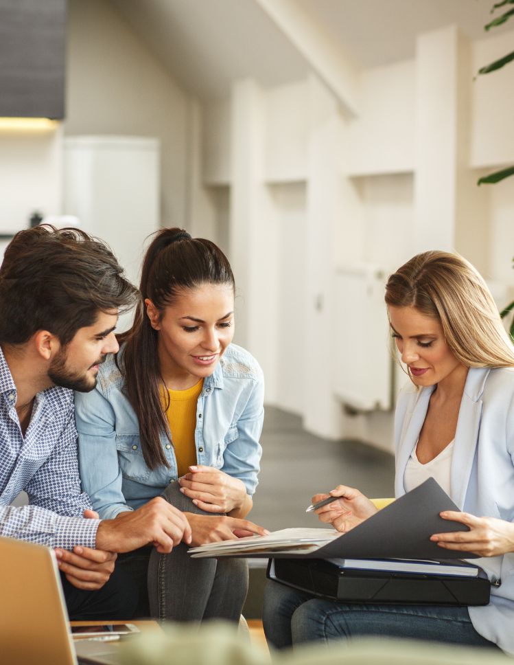 white area rug on hardwood floor with couch and art prints